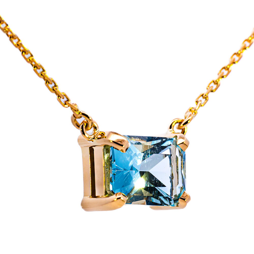 Emerald-cut blue gemstone pendant in a yellow gold claw setting, NY2K Jewellers, Maroochydore