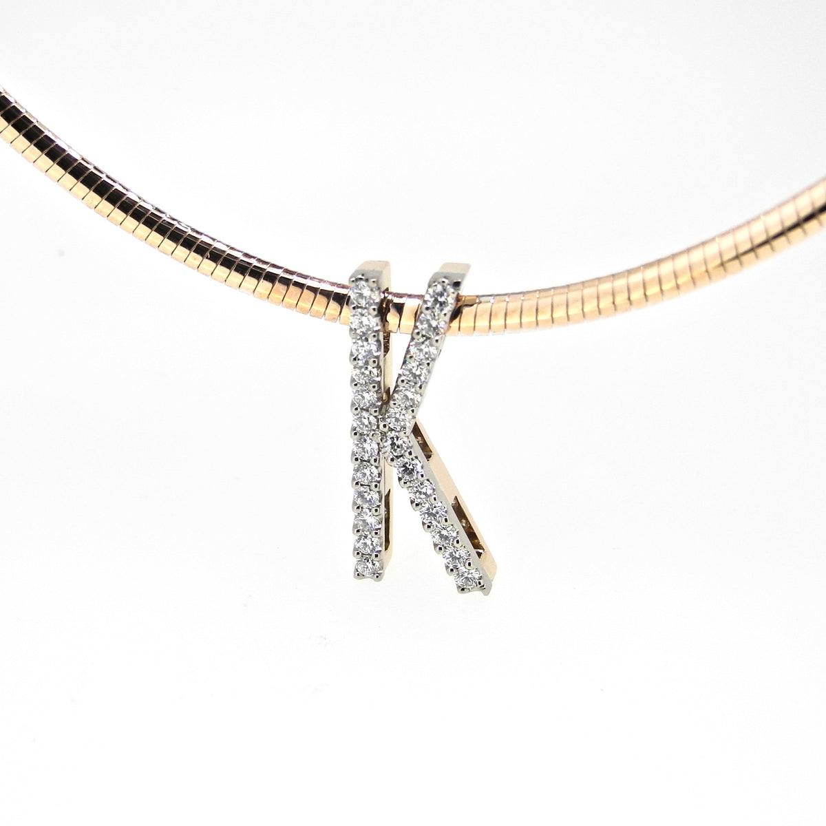 Diamond-set letter K pendant on a yellow gold collar, NY2K Jewellers, Maroochydore