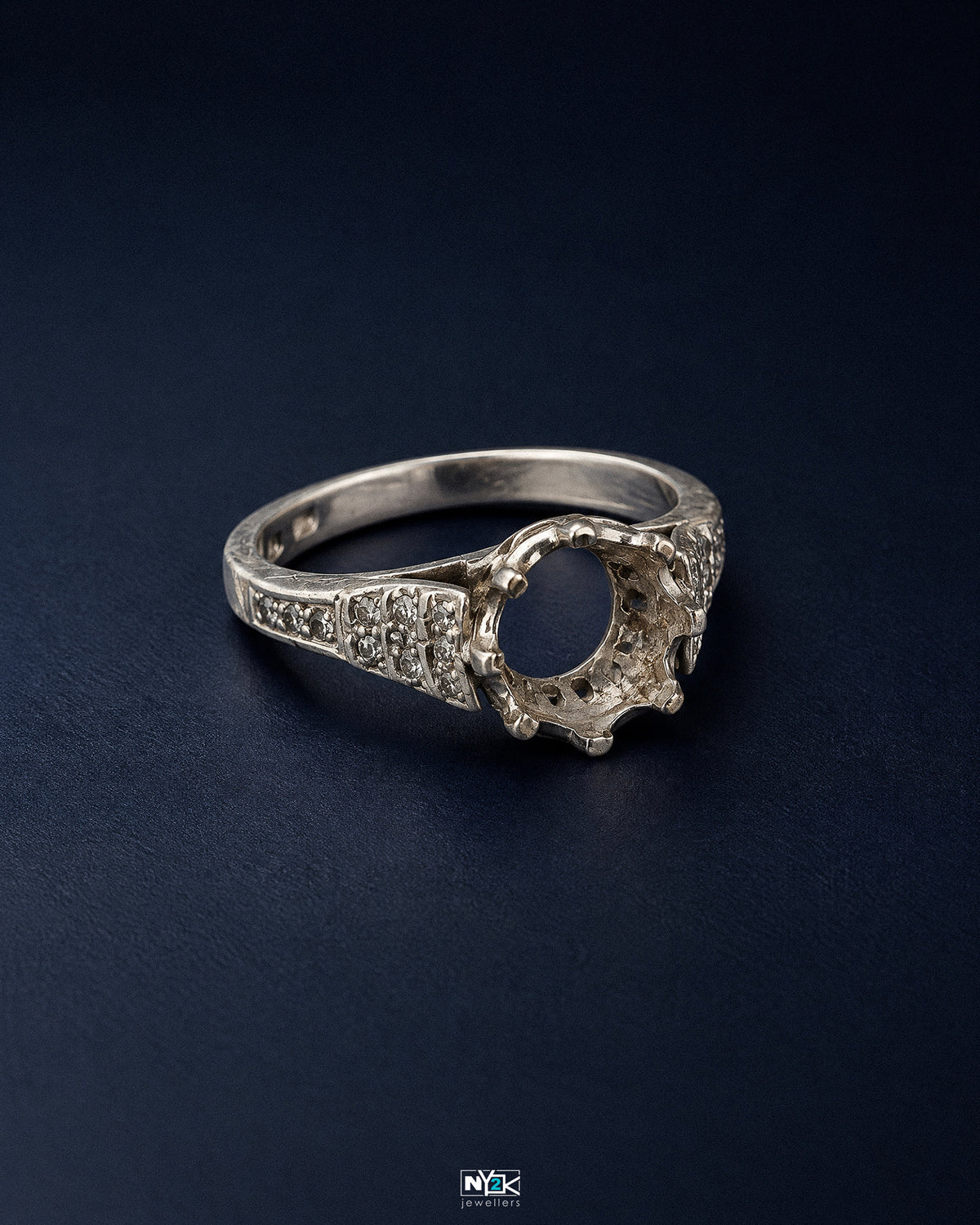 Maker's mark and metal stamp inside an antique band under raking light