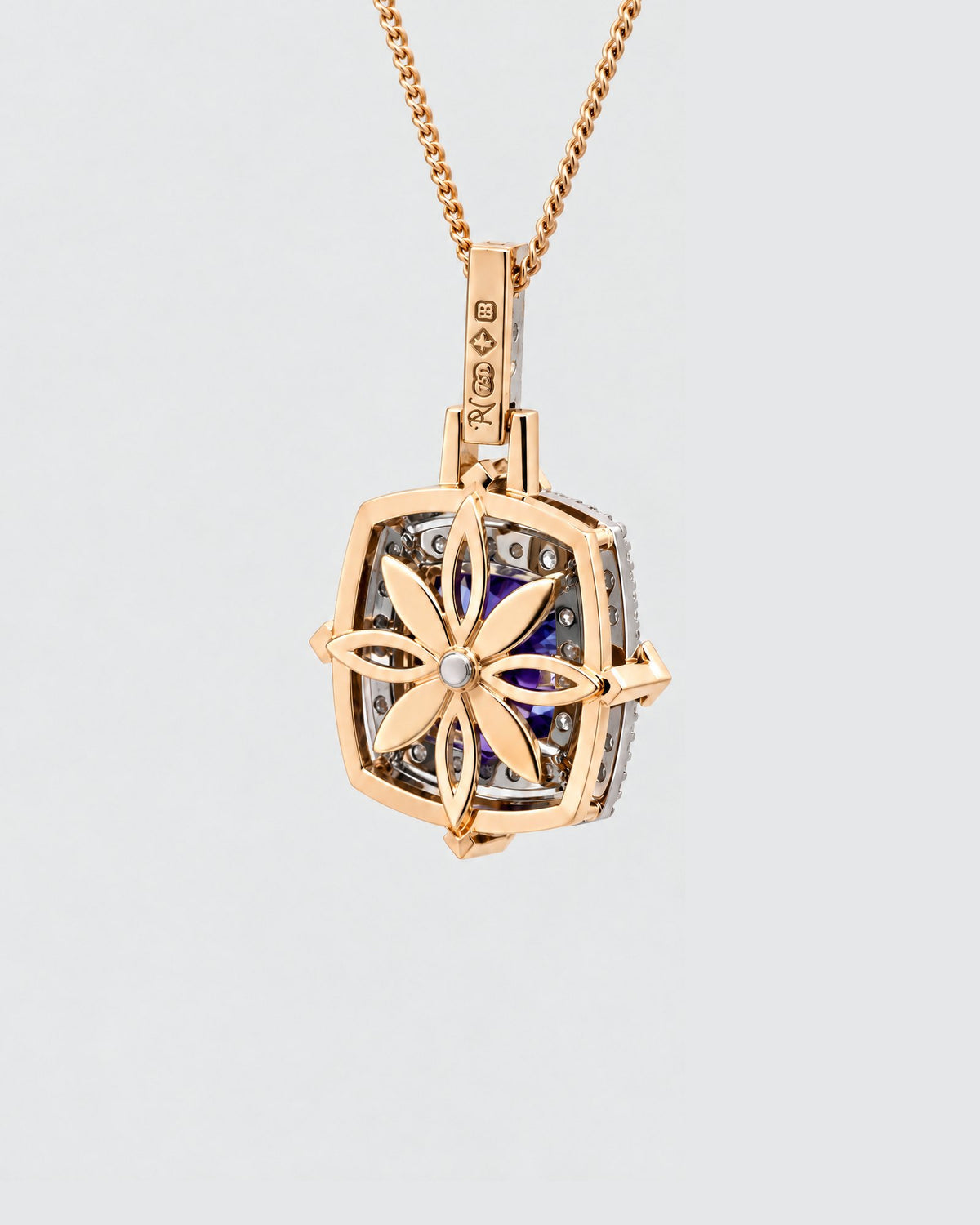 Back of the tanzanite pendant showing the pierced gallery and hallmarks