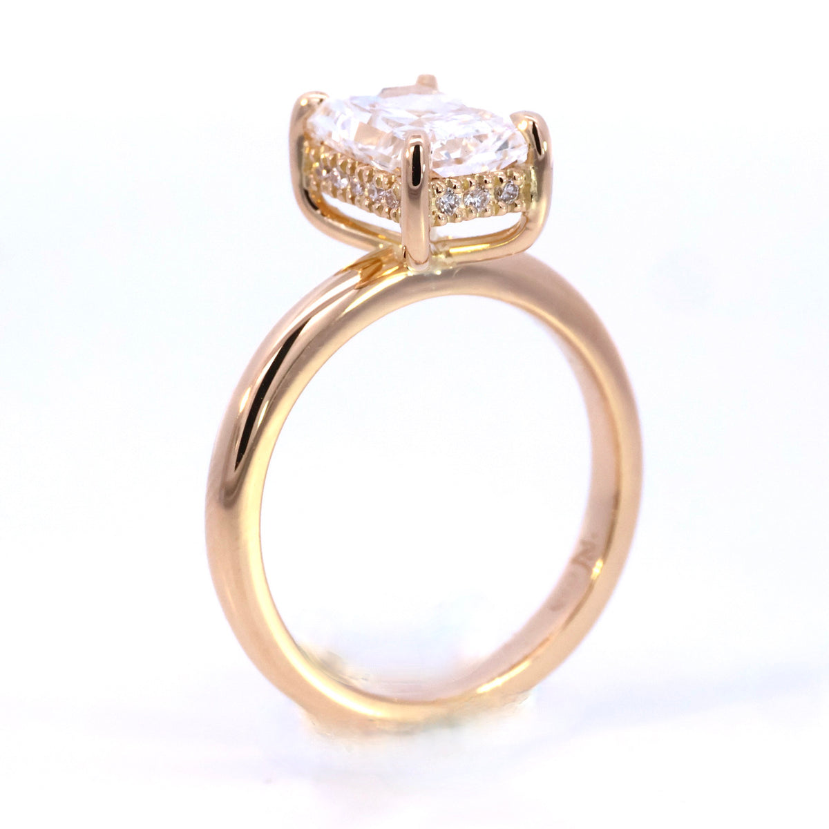 Rose gold solitaire ring with an emerald-cut centre stone and diamond-set basket, NY2K Jewellers, Maroochydore