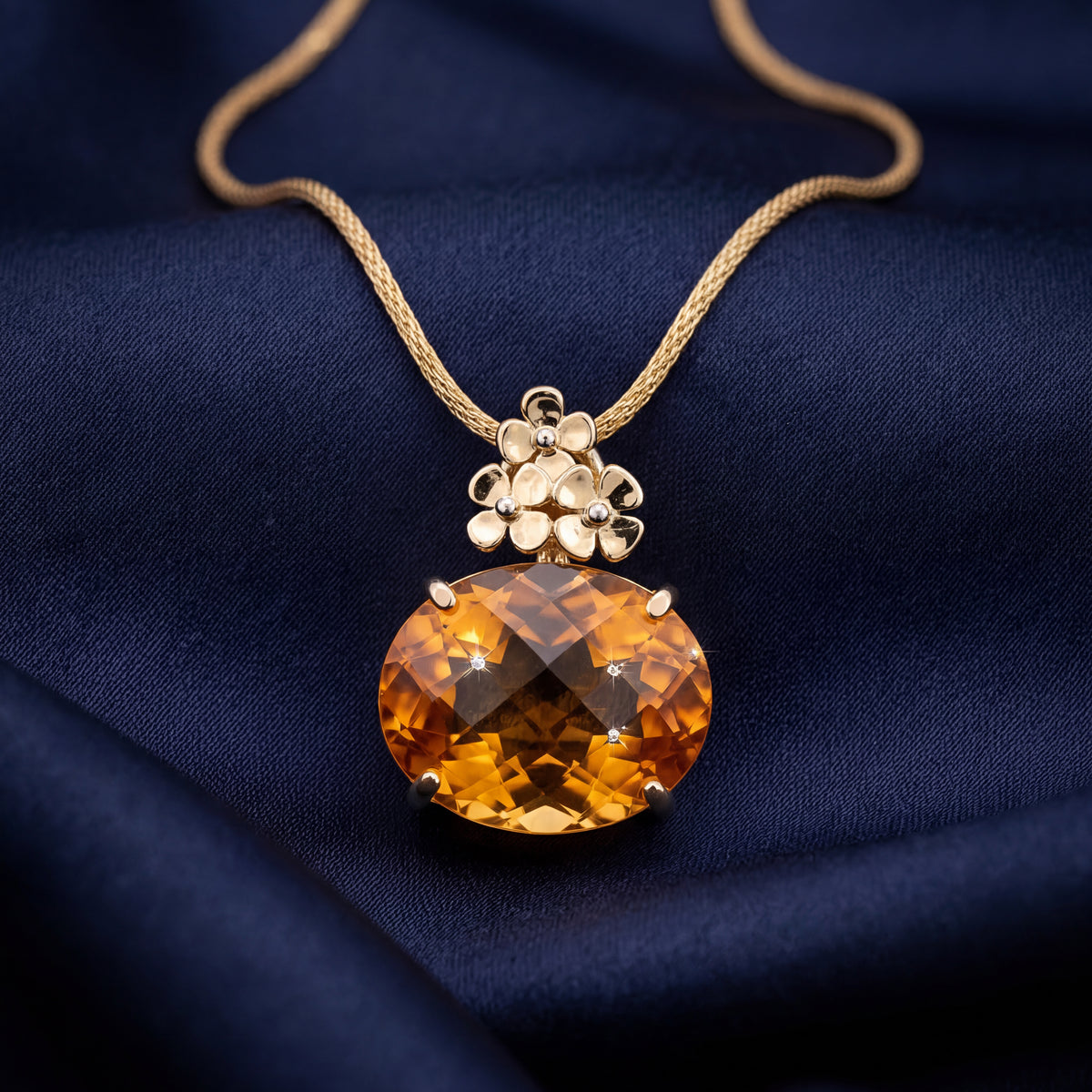 Orange gemstone pendant with gold flower detail on a gold chain, NY2K Jewellers, Maroochydore